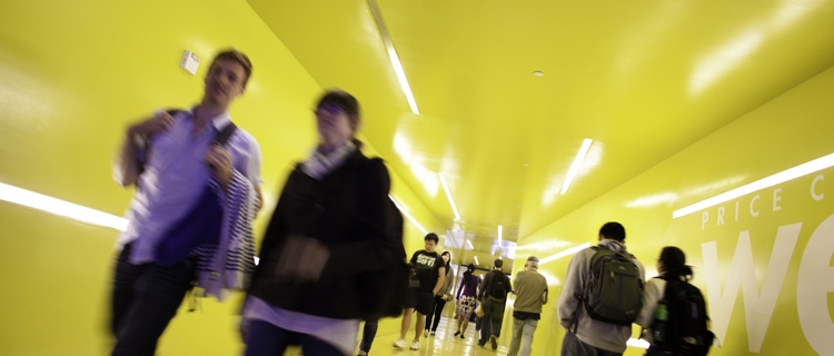 students walking through a yellow hallway at UC San Diego